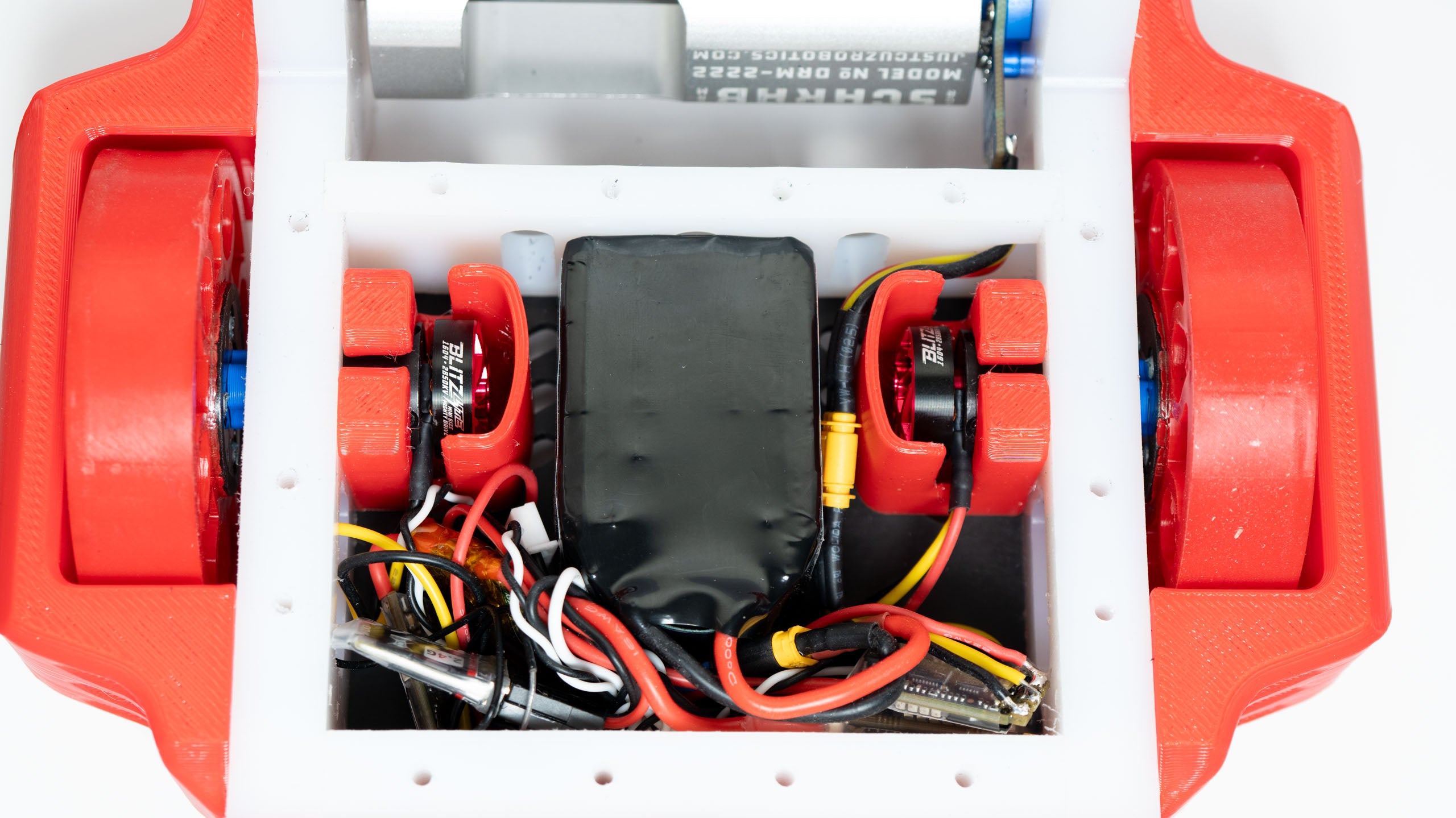 Close-up of electronic components inside a red and white device