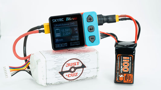 Battery pack with a digital display and labeled 'JUST CUZ' on a white background