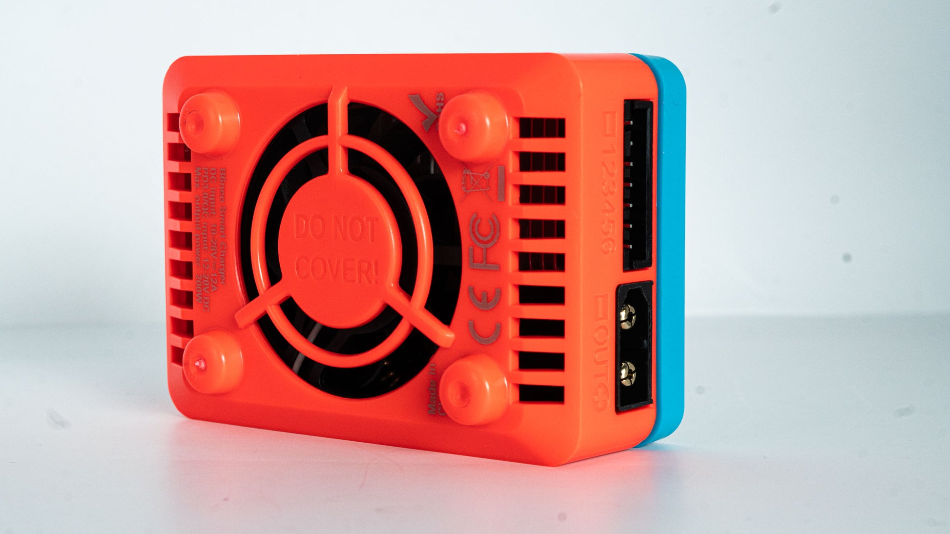 red and blue SkyRC B6 Neo electronic device with a fan on a white background