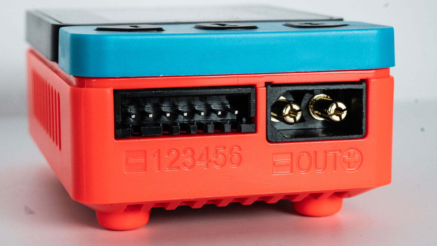 Red and blue electronic module with connectors on a white background