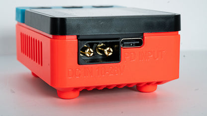 Red electronic device with connectors on a white background